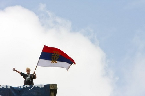 GAZIMESTAN, 28 June 2009 A woman waves a Serbian flag at the top of the Gazimestan